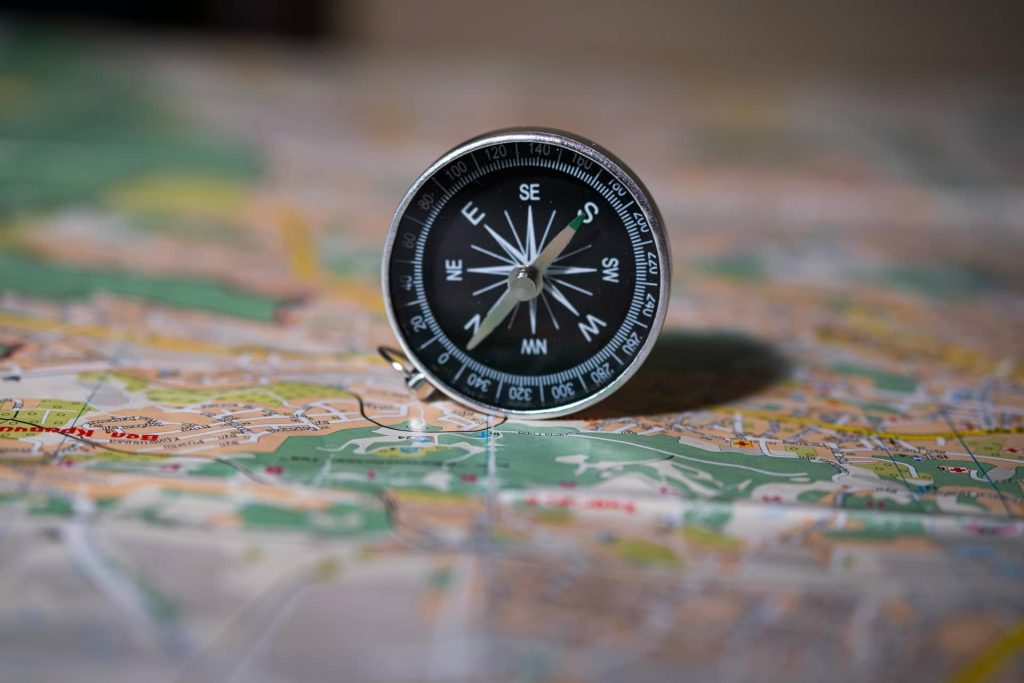 A black compass on a map
