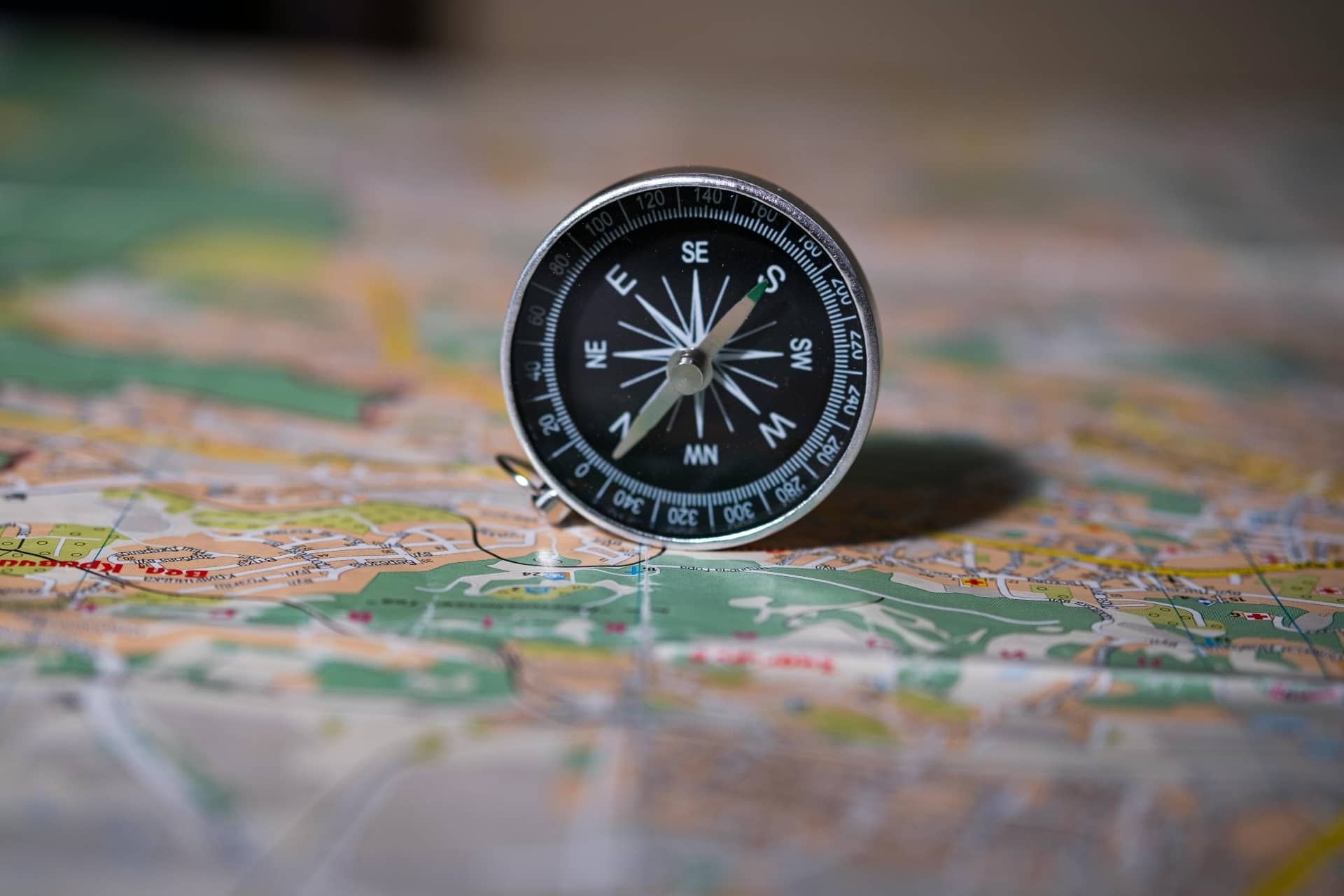 A compass standing on a map